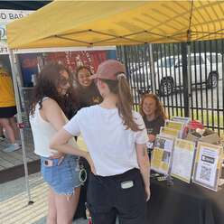 IRC staff talking with soccer game attendees.